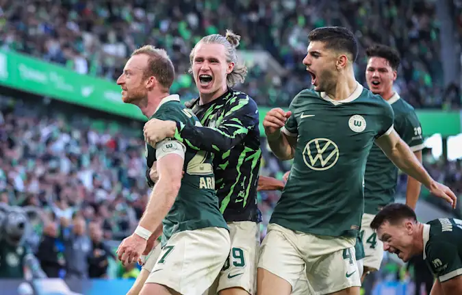 Maximilian Arnold, Patrick Wimmer and Konstantinos Koulierakis celebrate for Wolfsburg