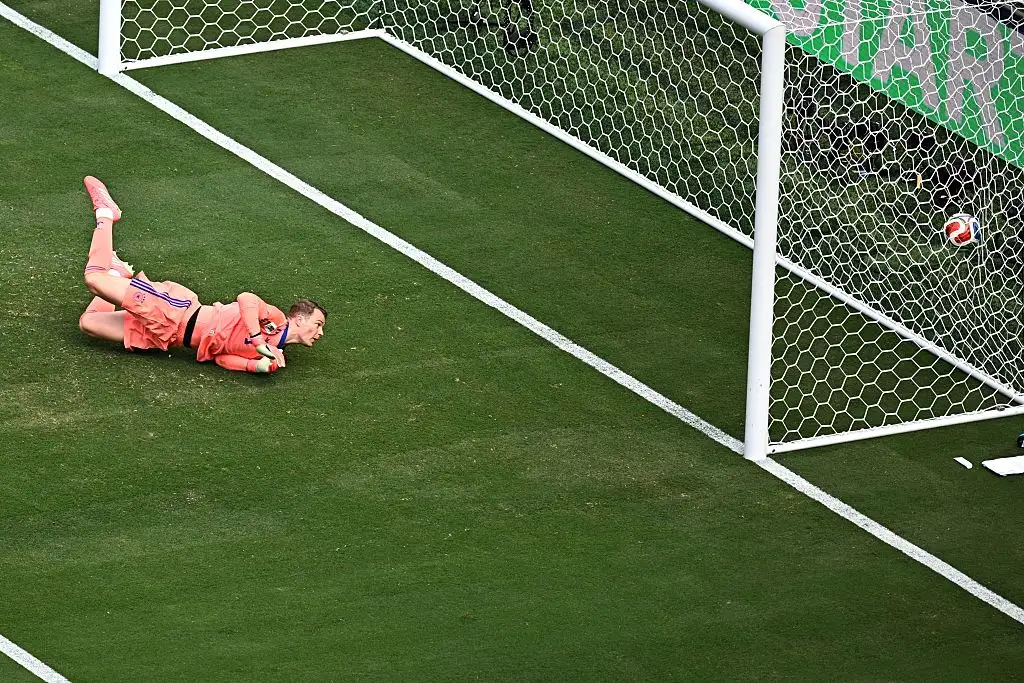 Goalkeeper Manuel Neuer (Germany) is unable to stop the shot that ties the game at 1-1.