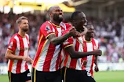 Michael Kayode of Brentford celebrates scoring with teammate Igor Thiago.