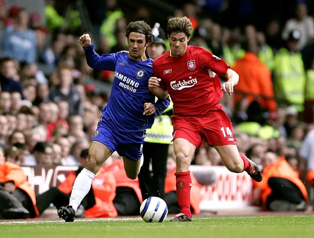 Liverpool's Xabi Alonso and Chelsea's Ricardo Carvalho battle for the ball.