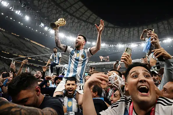 Lionel Messi celebrates Argentina's 2022 World Cup success with players and fans