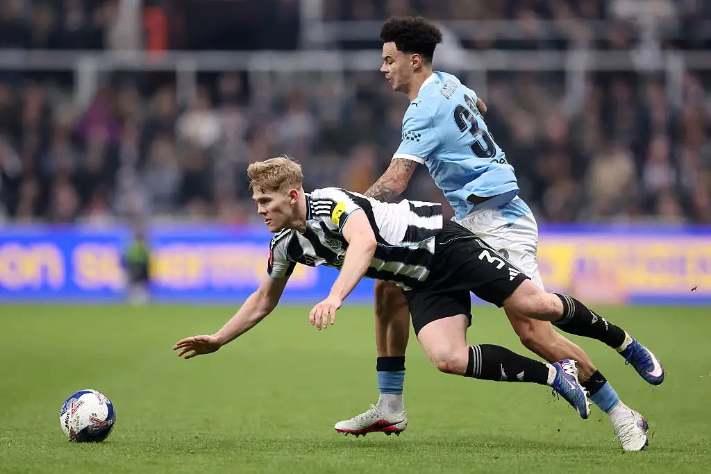 Lewis Hall of Newcastle United is challenged by Nico O'Reilly of Manchester City during the Emirates FA Cup Fifth Round match between Newcastle United and Manchester City at St. James' Park on March 07, 2026 in Newcastle upon Tyne, England