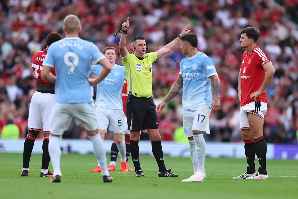 Players wait for Referee Michael Oliver to reveal the VAR decision for the goal scored by Erling Haaland of Manchester City during the Premier League 2026/27 match between Manchester United and Manchester City at Old Trafford on September 13, 2026 in Manchester, England