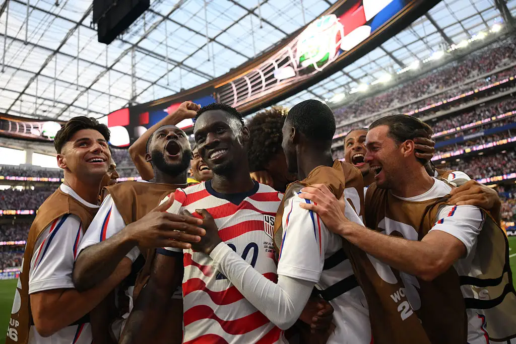 US forward #20 Folarin Balogun (c) celebrates with teammates after scoring his team's third goal during the 2026 World Cup Group D football match between USA and Paraguay at the Los Angeles Stadium in Inglewood on June 12, 2026