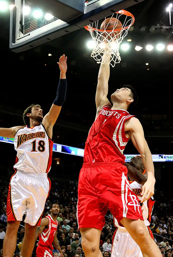 Yao Ming #11 of the Houston Rockets shoots over Marco Belinelli #18 of the Golden State Warriors during an NBA game on December 12, 2008 at Oracle Arena in Oakland, California.