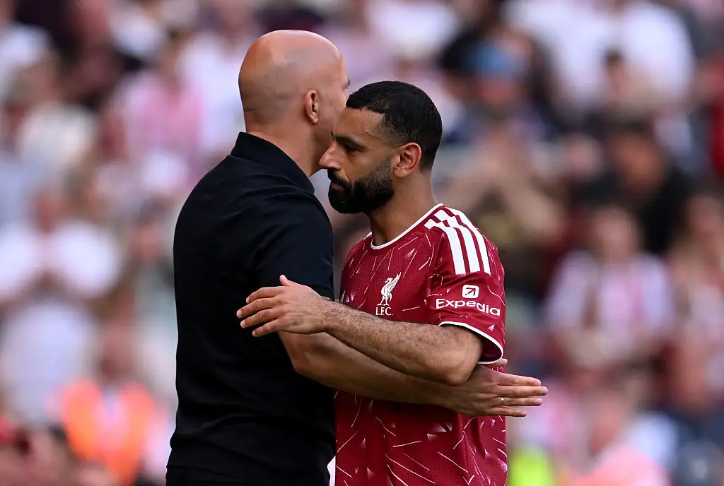 Mohamed Salah of Liverpool embraces Arne Slot, Manager of Liverpool, after being substituted off during the Premier League match between Liverpool and Brentford at Anfield on May 24, 2026 in Liverpool, England