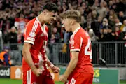 Aleksandar Pavlovic and Lennart Karl celebrate for Bayern against Club Brugge