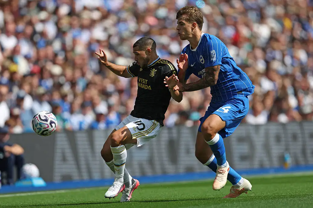 Emiliano Buendía of Aston Villa is challenged for the ball by Luka Vušković of Brighton & Hove Albion during the Premier League 2026/27 match between Brighton & Hove Albion and Aston Villa FC at American Express Stadium on August 23, 2026 in Brighton, England