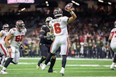 Tampa Bay Buccaneers quarterback Baker Mayfield winding up to throw a pass during a game.