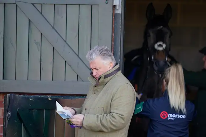  Paul Nicholls studies the racecard at Taunton Racecourse