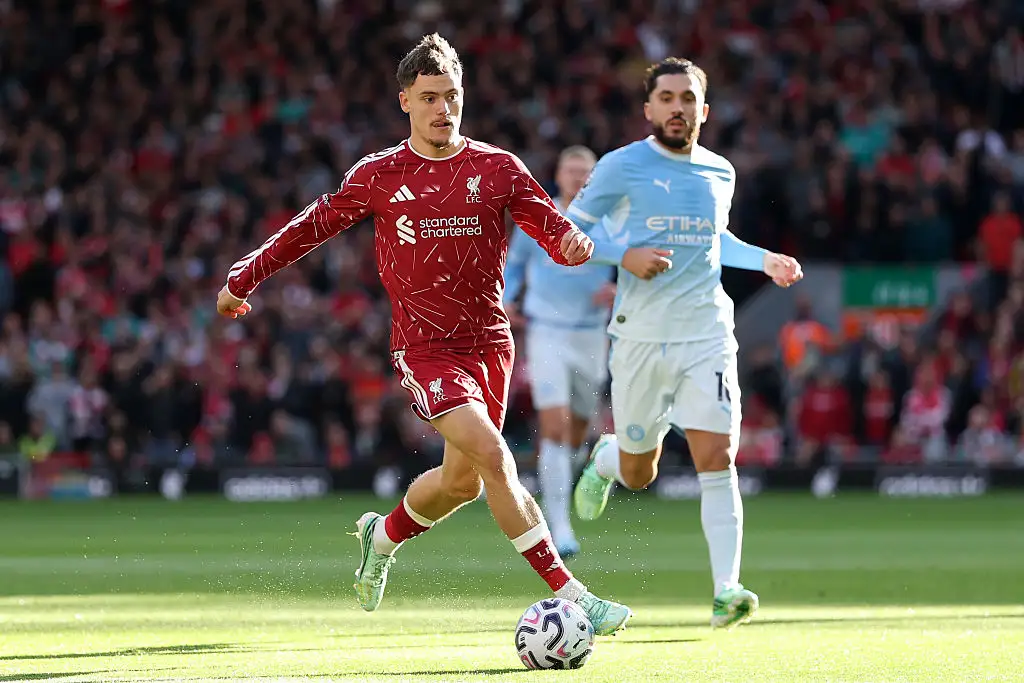 Florian Wirtz of Liverpool runs with the ball under pressure from Rayan Cherki of Manchester City during the Premier League 2026/27 match between Liverpool FC and Manchester City at Anfield on October 11, 2026 in Liverpool, England