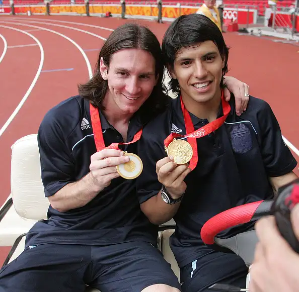 Lionel Messi and Sergio Aguero show off their 2008 Olympics Gold Medal
