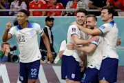 Jude Bellingham, Declan Rice, Luke Shaw and Harry Maguire of England celebrating during the FIFA World Cup Qatar 2022 Group B match between Wales and England