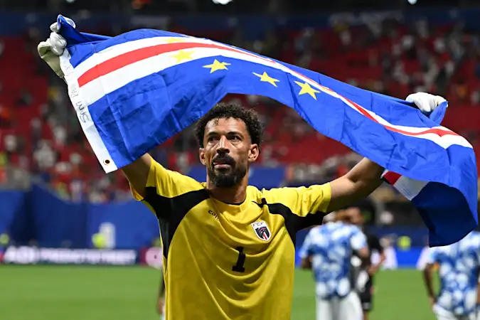 Vozinha celebrates with the Cape Verdean flag following his side's 0-0 draw with Spain