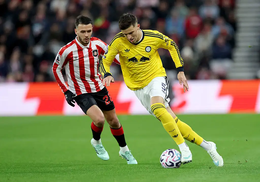 Tarik Muharemovic of Leeds United runs with the ball under pressure from Enzo Le Fee of Sunderland during the Premier League 2026/27 match between Sunderland and Leeds United at Stadium of Light on October 25, 2026 in Sunderland, England