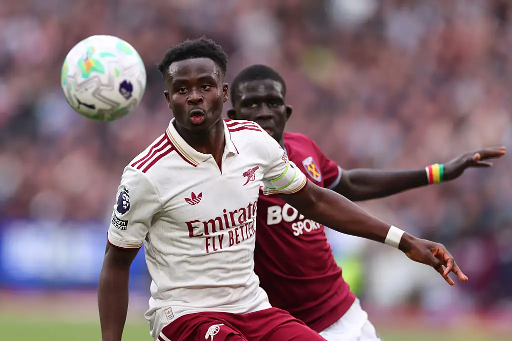 Bukayo Saka of Arsenal in action with El Hadji Malick Diouf of West Ham United during the Premier League match between West Ham United and Arsenal at London Stadium on May 10, 2026 in London, England