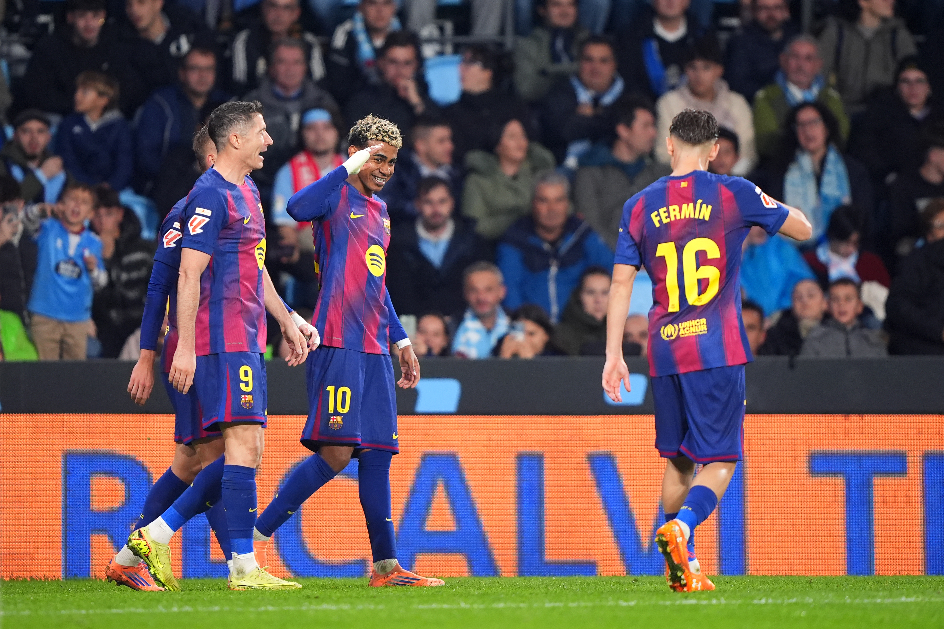Lamine Yamal celebrates with Robert Lewandowski and Fermin Lopez during Barcelona's 4-2 win over Celta Vigo